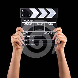 Human hand holding film clapper board isolated on black background