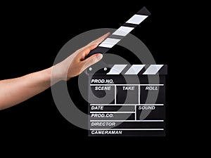 Human hand holding film clapper board isolated on black background