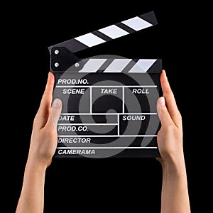 Human hand holding film clapper board isolated on black background