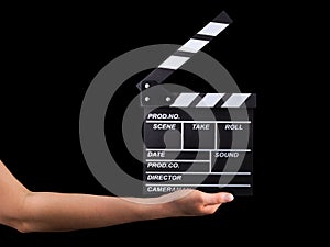 Human hand holding film clapper board isolated on black background