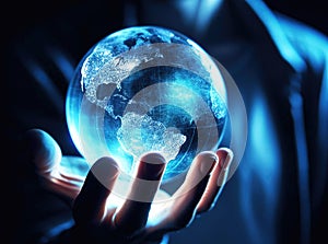 Human hand holding glass ball globe of the Earth with blue light inside, World environment and earth day concept
