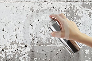 Human hand holding a graffiti Spray can