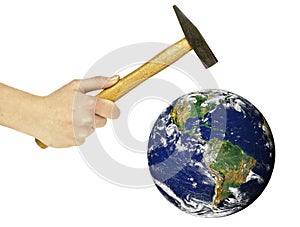 Human hand holding hammer and threatening to destroy planet Earth