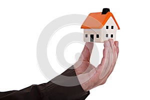 Human hand holding house