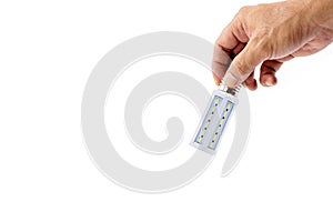 Human hand holding LED light bulb on white background