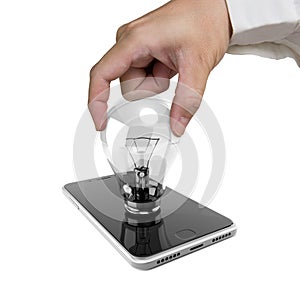 Human hand holding light bulb inserted in smart phone