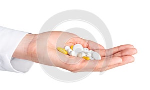 Human hand holding pills  on white background. Pharmacy, pharmacology, medicine background