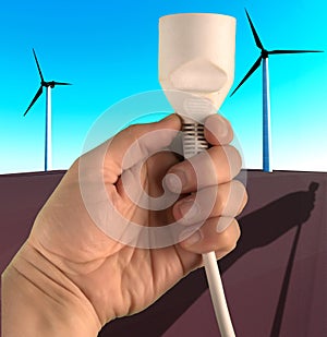 Human hand holding a plug against windmils