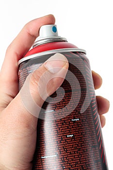 Human hand holding a spray cans