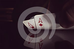 Human hand holding two ace