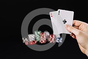 human hand holding two aces playing cards. High quality photo