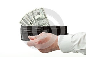 Human hand holding wallet with dollars