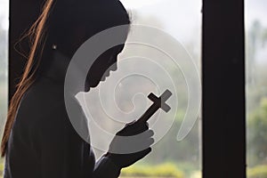 Human hand holds cross. prayer concept for faith, spirituality and religion Christian concept