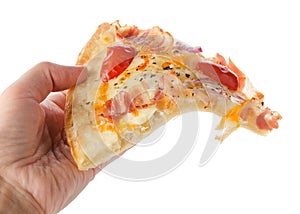 Human hand holds delicious pepperoni pizza slice isolated on white background