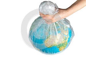 The human hand holds the earth in captivity. Globe in a white plastic bag. The concept of environmental disaster on a white