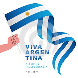 Human hand holds the flag of Argentina. July 9 - Viva Argentina - Independence Day of Argentina. Inscription is in Spanish