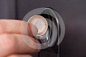 Human hand inserting coin