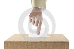 Human hand inserts vote paper into ballot box