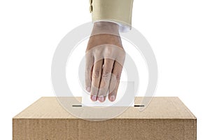 Human hand inserts vote paper into ballot box