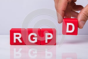 Human Hand Making Rgpd Word With Red Block photo