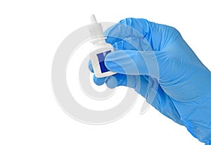 Human hand in medical glove is holding eye drop container.