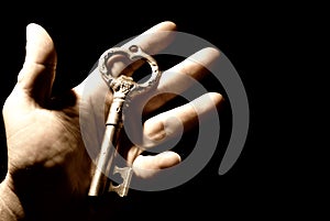 Human hand with an old key