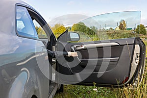 Human hand opens the car door In the countryside