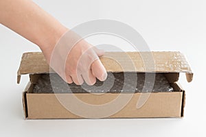 Human hand opens cardboard box