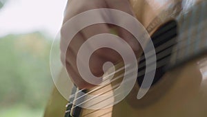 Human hand plays guitar closeup