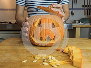 Human hand preparing pumpkin