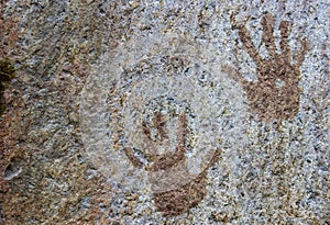 Human hand prints painted on stone surface