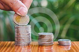 Human hand putting coins money stack step growing growth saving money, deposit Close up of person hand stacking golden coins,