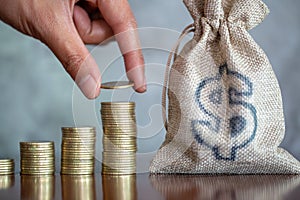 Human hand putting coins money stack step growing growth saving money, deposit Close up of person hand stacking golden coins,