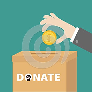 Human hand putting golden coin money with dollar sign into donation paper cardboard box. Helping hands concept. Donate and help