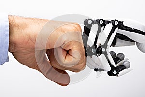 Human Hand And Robot Making Fist Bump