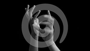 Human hand rounding his hands/wrists and dancing and creating imaginary globe isolated on the black concept of one world..