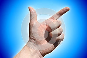 Human hand showing two fingers, blue background