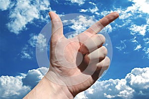 Human hand showing two fingers, sky