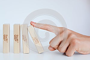 Human hand starting a domino effect concept