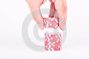 Human hand takeing red casino chips isolated on white