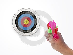 Human hand is throwing the darts target to the darts board. a man`s hand throws a dart at the target