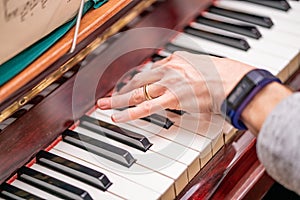 Human hand tinkering the ivories and playing a melodic tune