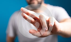 Human hand touching screen isolated on blue background