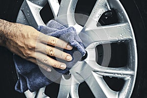 Human hand is wipe the alloy wheel