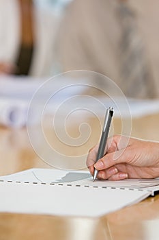 Human hand writing on notepad