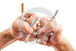 Human hands heatedly breaking cigarettes