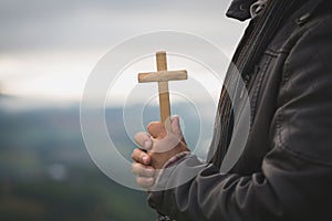 Human hands holding a cross holy and prayed for blessings from God, Amour Worship God concept. - Image