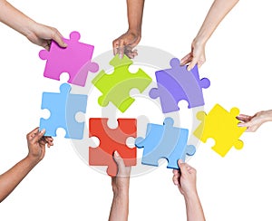 Human Hands Holding Jigsaw Puzzle photo