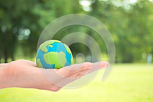 Human hands holding planet or earth