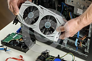 Human hands are inserting a video card